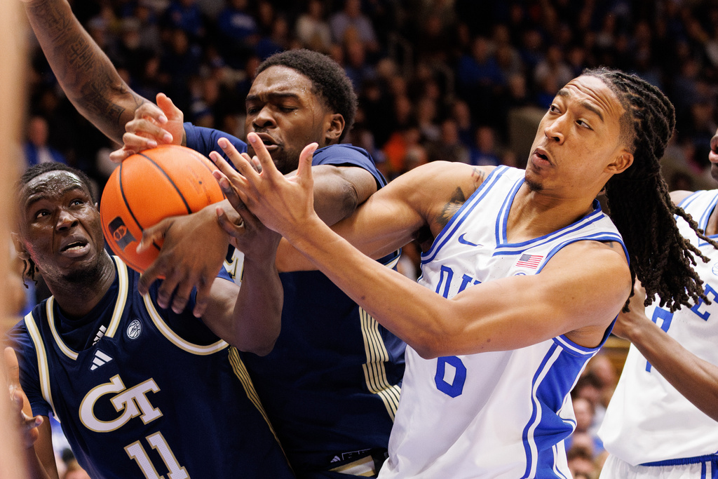 Duke's Maliq Brown, right, battles for a rebound with Georgia Tech's Baye Ndongo (11) and Peyton Marshall, middle, during the first half of an NCAA college basketball game in Durham, N.C., Wednesday, Dec. 31, 2025. (AP Photo/Ben McKeown)