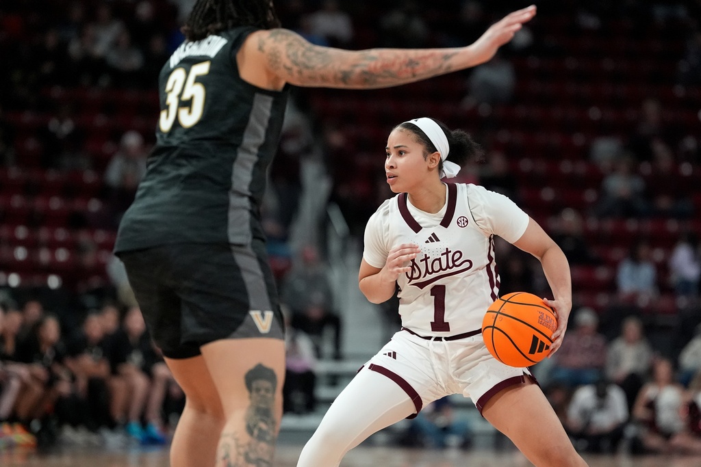 Mississippi State guard Saniyah King (1) looks for an open teammate to pass to while pressured by Vanderbilt forward Sacha Washington (35) during the second half of an NCAA college basketball game, Thursday, Jan. 15, 2026, in Starkville, Miss. (AP Photo/Rogelio V. Solis)
