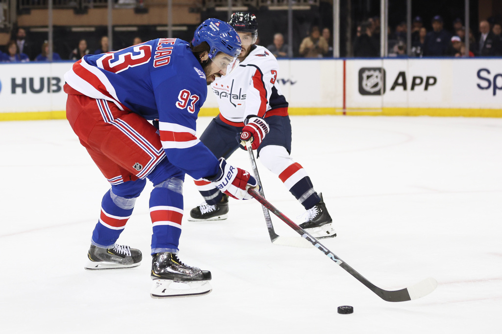 New York Rangers' Mika Zibanejad (93) looks to take a shot past Washington Capitals' Matt Roy (3) during the first period of an NHL hockey game, Sunday, Oct. 12, 2025, in New York. (AP Photo/Heather Khalifa)