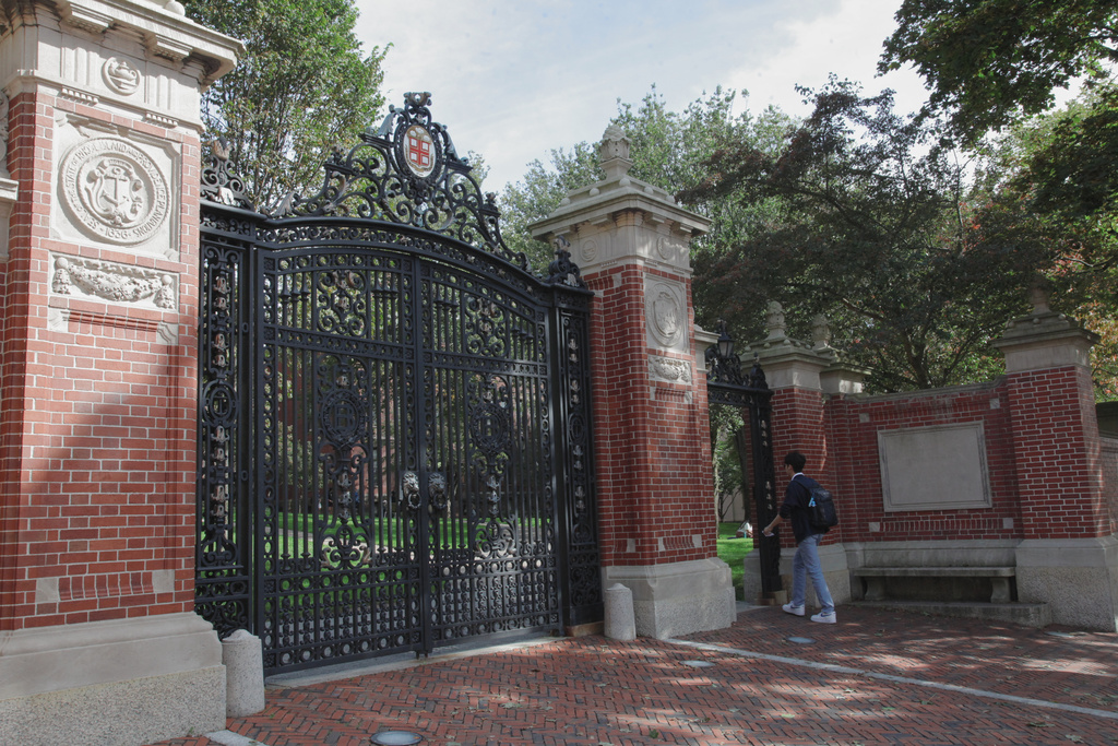 A student walks at a gate to Brown University, Monday, Sept. 29, 2025, in Providence, R.I. (AP Photo/Kimberlee Kruesi)
