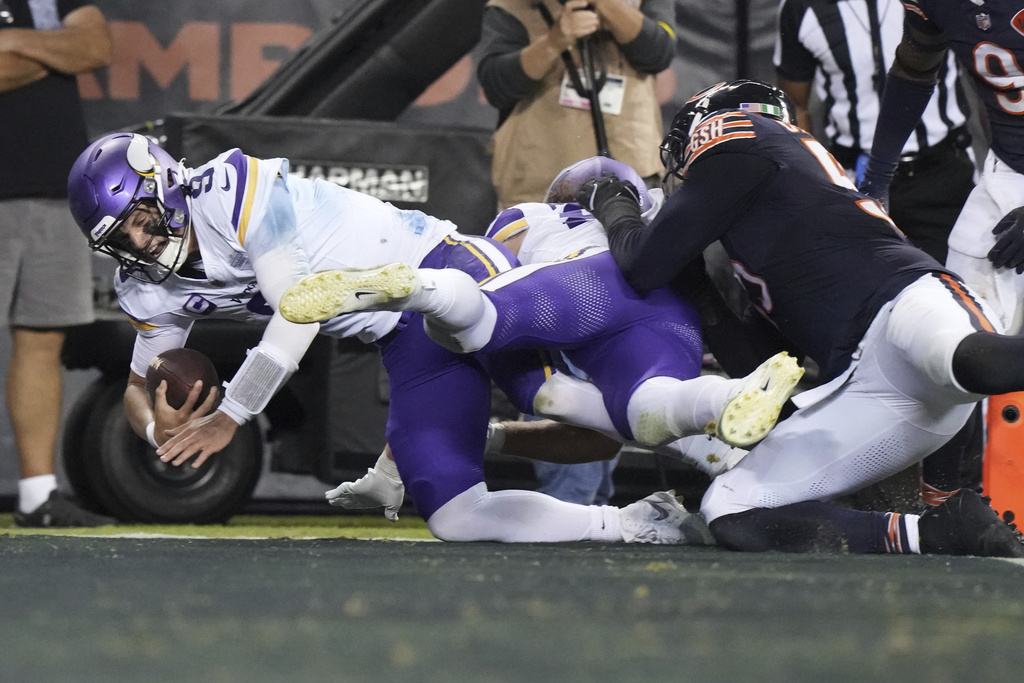 Minnesota Vikings quarterback J.J. McCarthy (9) scores on an 14-yard touchdown run during the second half of an NFL football game against the Chicago Bears Monday, Sept. 8, 2025, in Chicago. (AP Photo/Nam Y. Huh)
