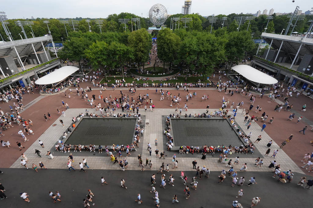 Spectators walk around the grounds of the USTA Billie Jean King National Tennis Center during the first round of the U.S. Open tennis championships Sunday, Aug. 30, 2026, in New York. (AP Photo/Frank Franklin II)