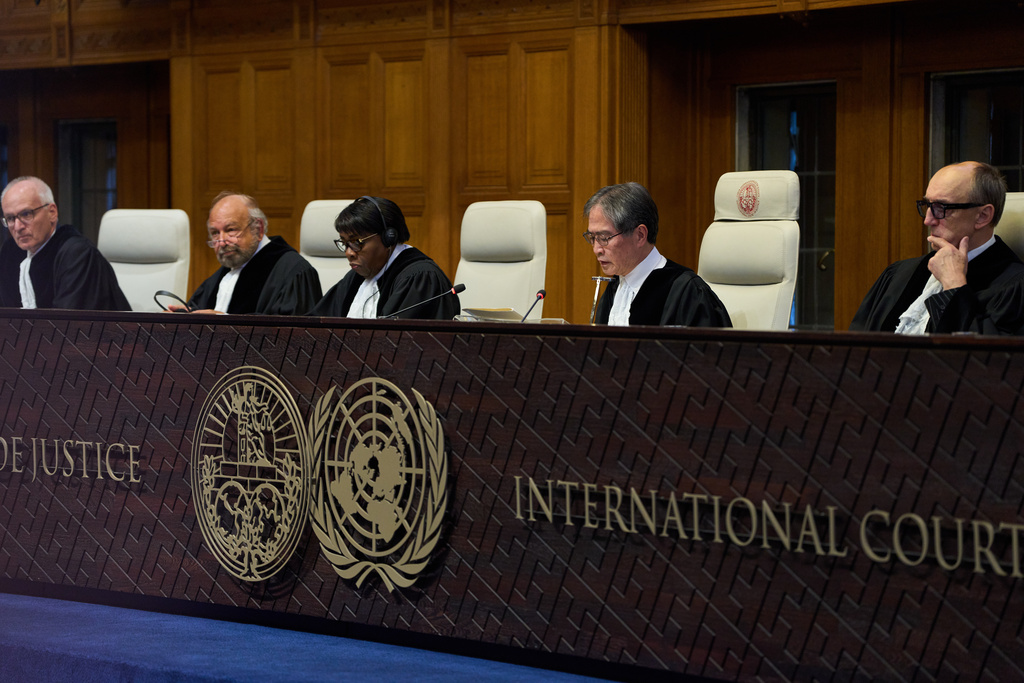 Presiding Judge Yuji Iwasawa, second right, starts reading the advisory opinion of the International Court of Justice on what Israel must do to ensure humanitarian aid reaches Palestinians in Gaza and the occupied West Bank, in The Hague, Netherlands, Wednesday, Oct. 22, 2025. (AP Photo/Peter Dejong)
