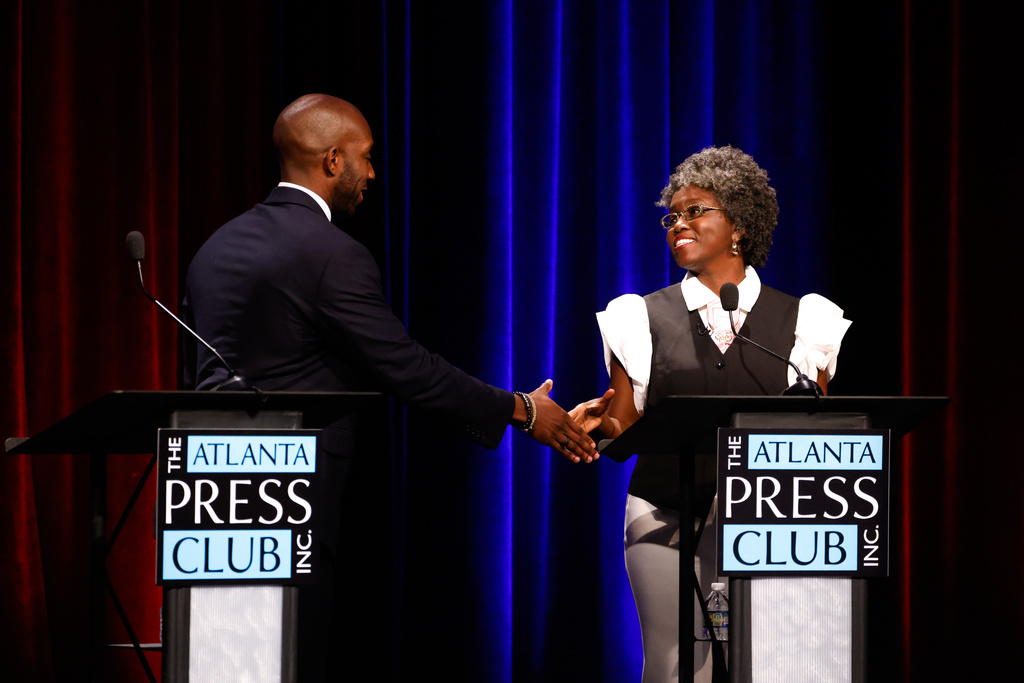 Democratic candidates for Congress, Everton Blair, left, and Jasmine Clark shake hands after the Atlanta Press Club Loudermilk-Young District 13 primary election debate at Georgia Public Broadcasting, Monday, April 27, 2026, in Atlanta. (Arvin Temkar/Atlanta Journal-Constitution via AP)