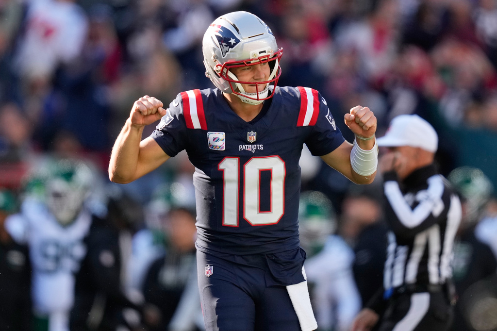 New England Patriots quarterback Drake Maye (10) celebrates after tight end Hunter Henry scored a touchdown during the second half of an NFL football game against the New York Jets in Foxborough, Mass., Sunday, Oct. 18, 2026. (AP Photo/Charles Krupa)
