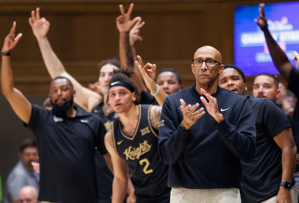 Central Florida head coach Johnny Dawkins claps for his team during the first half of an NCAA college basketball game against Duke in Durham, N.C., Tuesday, Oct. 21, 2025. (AP Photo/Ben McKeown)