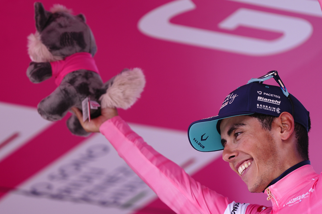 Portugal's Afonso Oliveira Eulalio wears the pink jersey of the race overall leader as he stands on the podium after completing the 10th stage of the Giro d'Italia cycling race from Viareggio to Massa, Italy, Tuesday May 19, 2026. (Fabi Ferrari/LaPresse via AP)