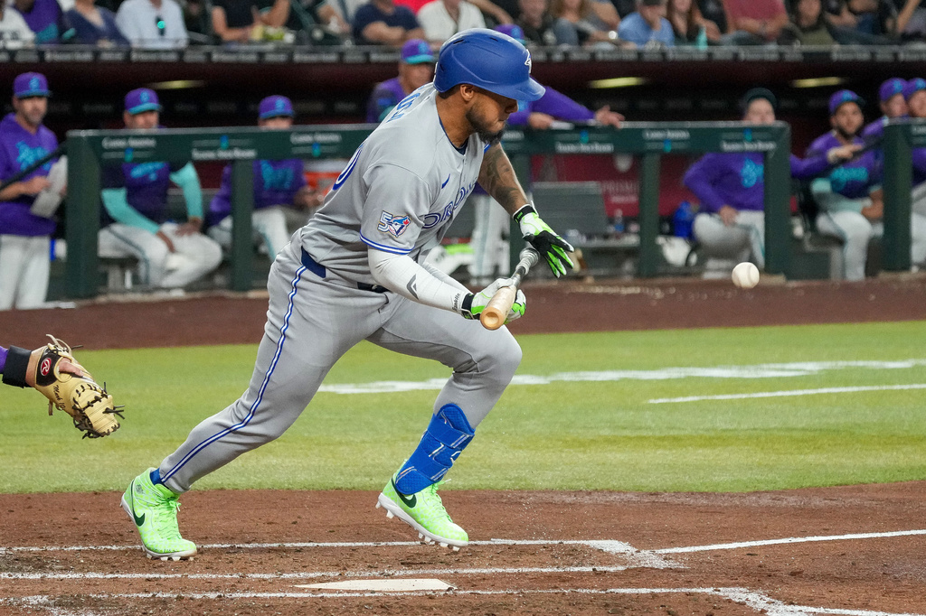 Toronto Blue Jays' Lenyn Sosa lays down a bunt against the Arizona Diamondbacks during the fourth inning of an baseball game Friday, April 17, 2026, in Phoenix. (AP Photo/Darryl Webb)