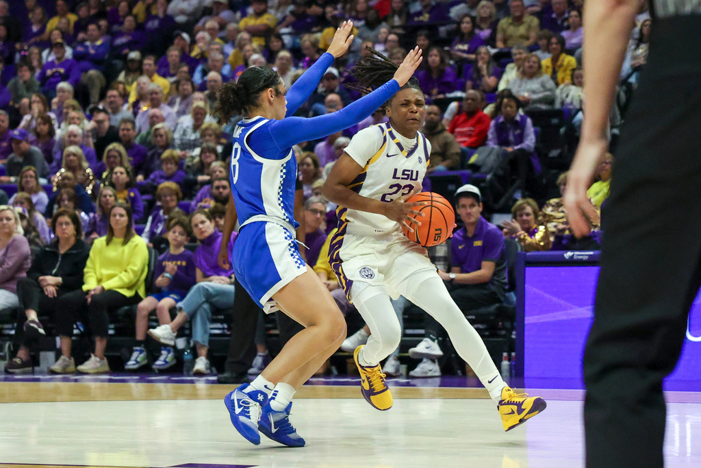 LSU guard MiLaysia Fulwiley tries to drive past Kentucky guard Asia Boone, left, in the first half of an NCAA college basketball game in Baton Rouge, La., Thursday, Jan. 1, 2026. (AP Photo/Peter Forest)