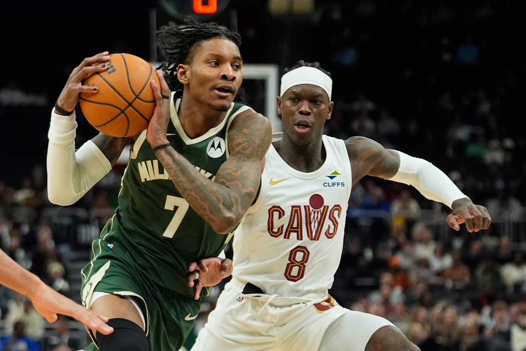 Milwaukee Bucks' Kevin Porter Jr. (7) drives to the basket against Cleveland Cavaliers' Dennis Schröder during the second half of an NBA basketball game Wednesday, Feb. 25, 2026, in Milwaukee. (AP Photo/Aaron Gash)