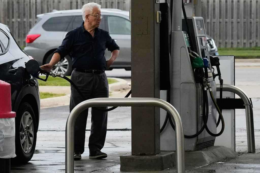 A customer checks gas price while he fills up his vehicle's tank at a gas station, in Streamwood, Ill., Wednesday, Sept. 16, 2026. (AP Photo/Nam Y. Huh)