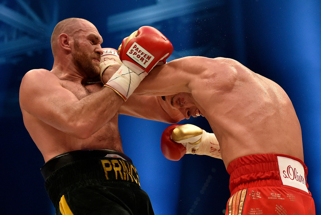 FILE - Ukraine's Wladimir Klitschko, right, and Britain's Tyson Fury, left, exchange blows as Fury wins the world heavyweight title fight for Klitschko's WBA, IBF, WBO and IBO belts in the Esprit Arena in Duesseldorf, western Germany, Saturday, Nov. 28, 2015. (AP Photo/Martin Meissner, File)
