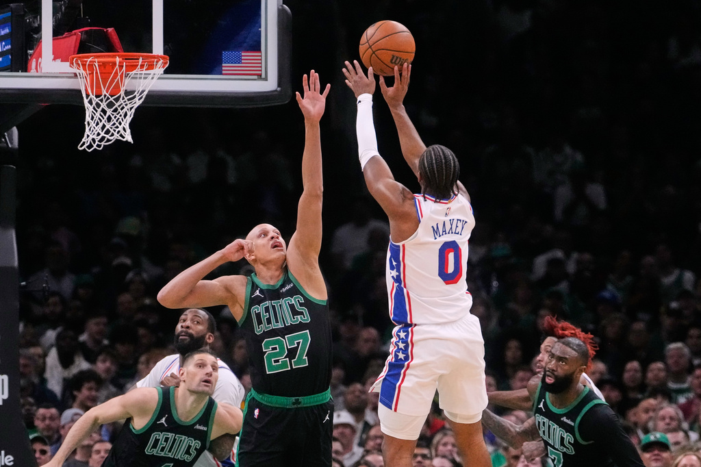 Philadelphia 76ers guard Tyrese Maxey (0) takes a shot over Boston Celtics guard Jordan Walsh (27) during the first half of Game 5 of a first-round NBA playoffs basketball series, Tuesday, April 28, 2026, in Boston. (AP Photo/Charles Krupa)