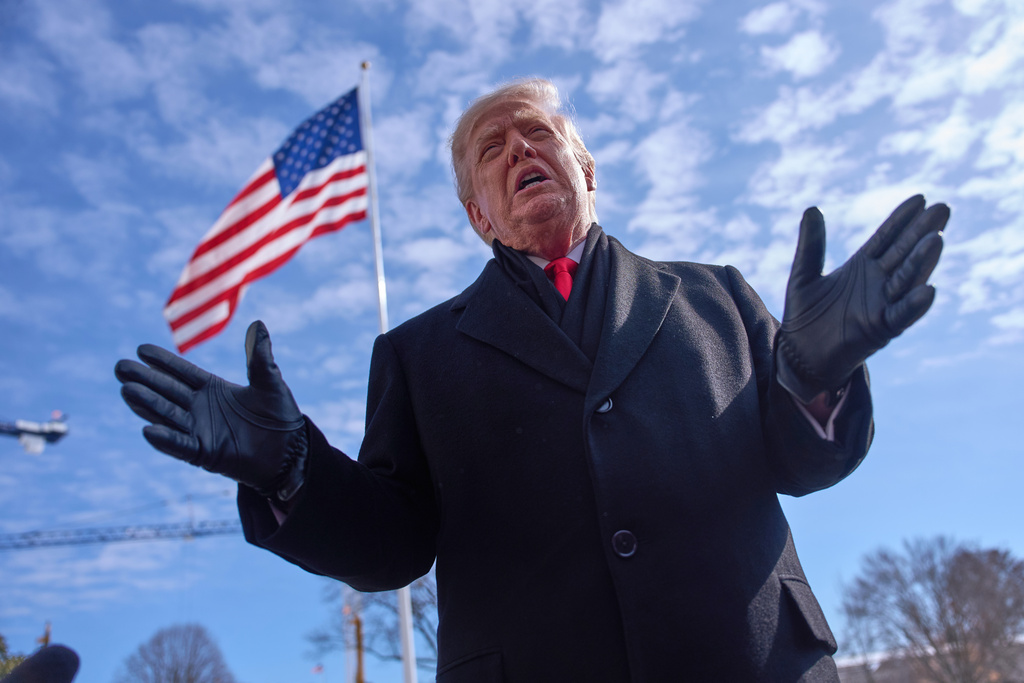 President Donald Trump speaks with reporters before boarding Marine One on South Lawn of the White House, Tuesday, Jan. 27, 2026, in Washington. (AP Photo/Evan Vucci)