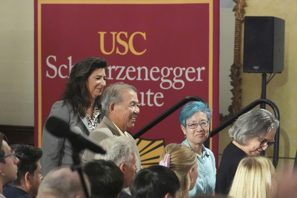 Members of the California Citizens Redistricting Commission, from left, Jodie Filkins, Peter Yao, Cynthia Dai, and Jeanne Raya, are introduced by former California Gov. Arnold Schwarzenegger during a talk with University of Southern California interim president Beong-Soo Kim on a conversation on democracy and Schwarzenegger's opposition to Proposition 50, a California ballot measure to redraw U.S. House maps to boost Democrats, at the USC campus in Los Angeles, Monday, Sept. 15, 2025. (AP Photo/Damian Dovarganes)