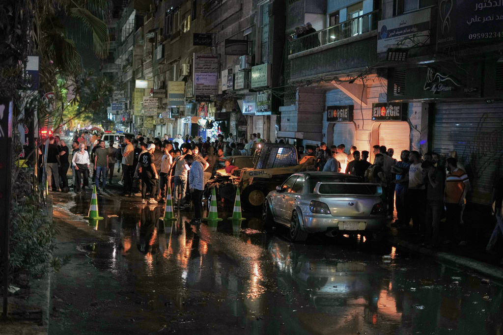 Residents gather near the site of an explosion in the Jaramana suburb, home to a large Druze population, in Damascus, Syria, Thursday, Aug. 6, 2026. (AP Photo/Omar Albam)