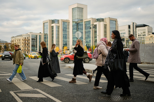 People cross a street, with Russian oil company Lukoil's headquarters seen in the background, in Moscow, Russia, Thursday, Oct. 23, 2025. (AP Photo/Pavel Bednyakov) People cross a street, with Russian oil company Lukoil's headquarters seen in the background, in Moscow, Russia, Thursday, Oct. 23, 2025. (AP Photo/Pavel Bednyakov)