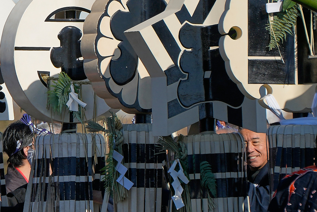 Members of a traditional firefighting preservation group hold a matoi, a traditional flag once used by Edo-period fire brigades during the annual New Year's Fire Brigade Review Tuesday, Jan. 6, 2026, in Tokyo. (AP Photo/Eugene Hoshiko)