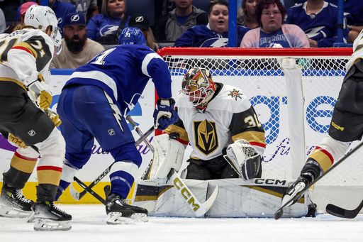 In his NHL debut, Vegas Golden Knights goaltender Carl Lindbom (30) makes a save against Tampa Bay Lightning's Anthony Cirelli (71) during the first period of a hockey game Sunday, Oct. 26, 2025, in Tampa, Fla. (AP Photo/Mike Carlson) In his NHL debut, Vegas Golden Knights goaltender Carl Lindbom (30) makes a save against Tampa Bay Lightning's Anthony Cirelli (71) during the first period of a hockey game Sunday, Oct. 26, 2025, in Tampa, Fla. (AP Photo/Mike Carlson)