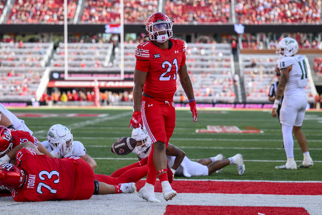Utah running back NaQuari Rogers (21) drops the ball in celebration after scoring a touchdown during an NCAA college football game against Cal Poly, Saturday, Sept. 6, 2025, in Salt Lake City, Utah. (AP Photo/Tyler Tate)