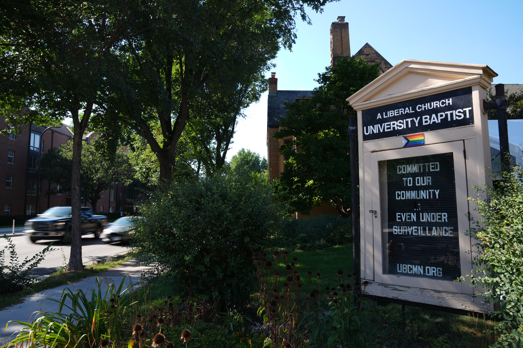 A sign denouncing surveillance is seen outside University Baptist Church, Friday, Sept. 4, 2026, in Minneapolis. (AP Photo/Ellen Schmidt)