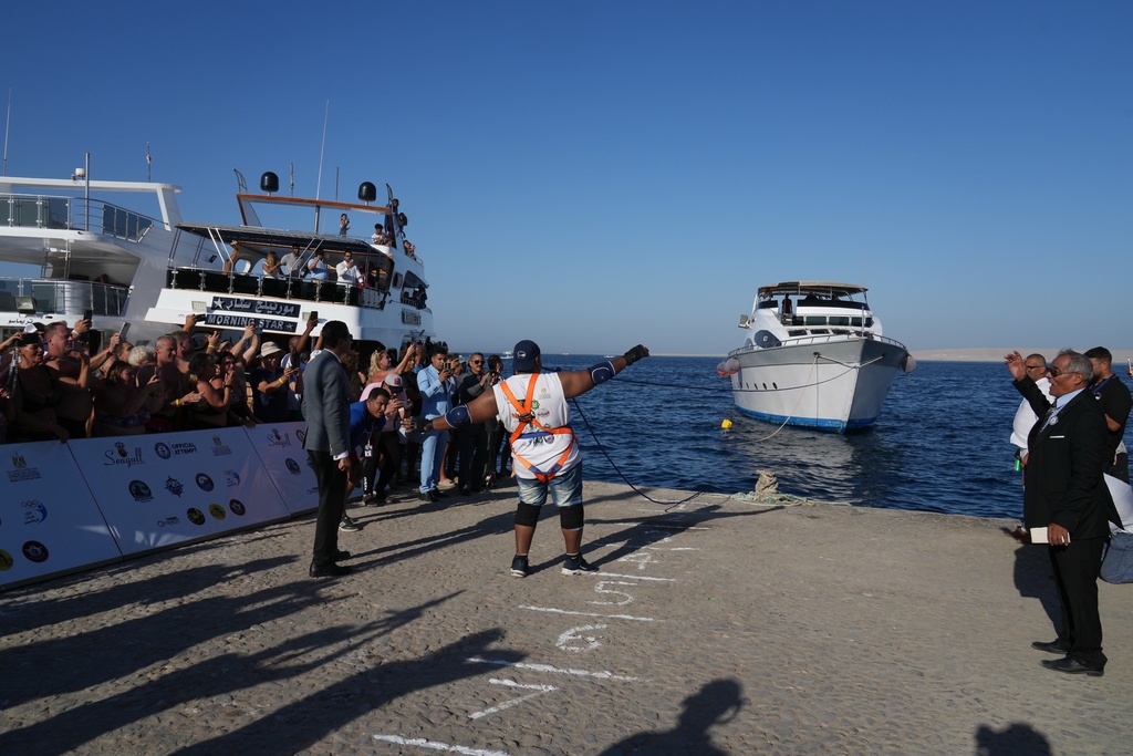 Egyptian wrestler Ashraf Mahrous, better known as Kabonga, pulls a 700-ton ship across the water using only a rope held in his teeth at the marina in the Red Sea resort of Hurghada, Egypt, Saturday, Sept. 27, 2025. (AP Photo/Amr Nabil)