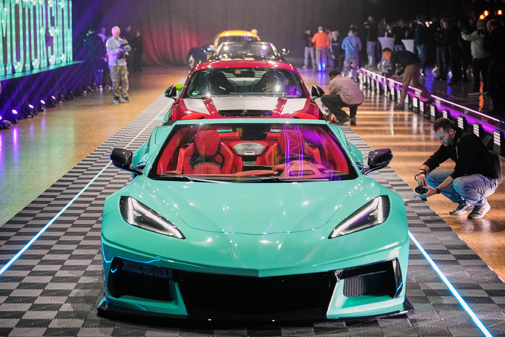 A custom made Chevrolet Corvette C8 is seen with other show cars on a carpet during a carwalk at a preview of the Essen Motor Show in Essen, Germany, Tuesday, Oct. 28, 2025. (AP Photo/Martin Meissner)