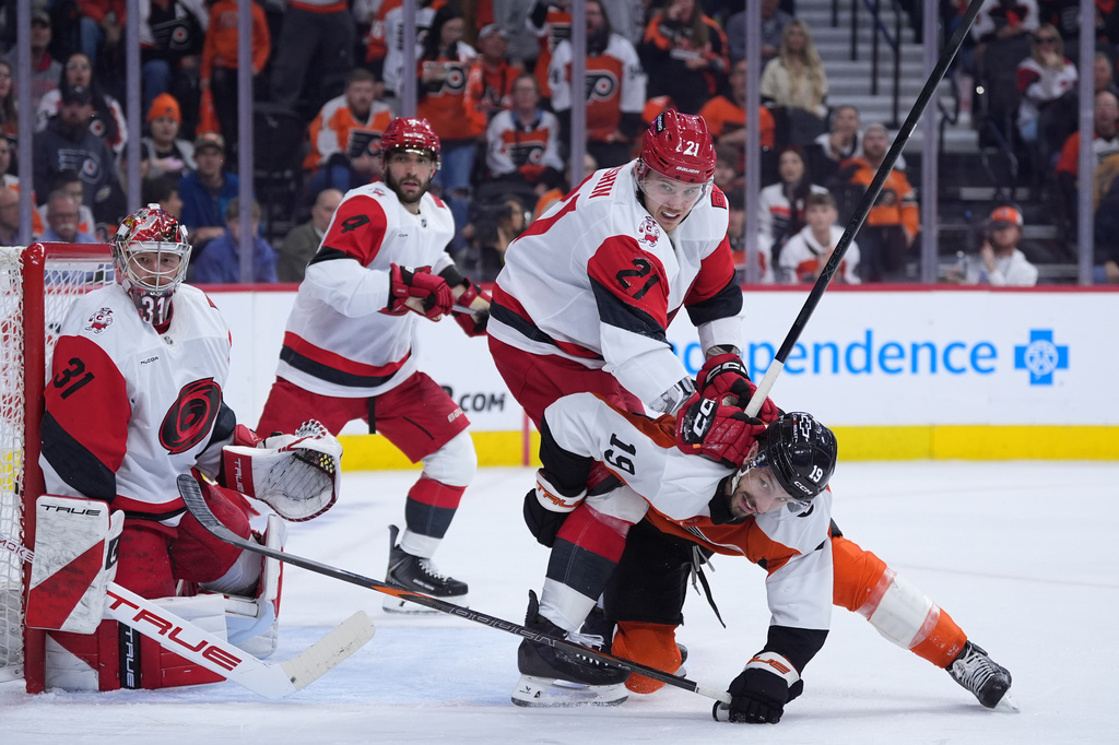 Carolina Hurricanes' Alexander Nikishin battles with Philadelphia Flyers' Garnet Hathaway (19) during the second period of Game 4 in a second-round NHL hockey Stanley Cup playoff series, Saturday, May 9, 2026, in Philadelphia. (AP Photo/Matt Slocum)