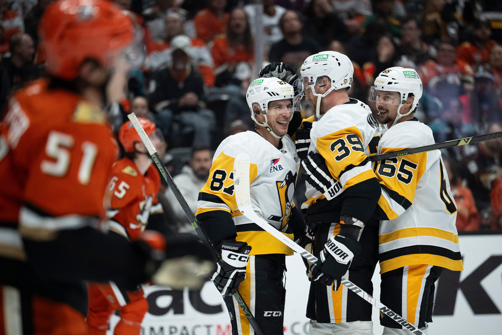 Pittsburgh Penguins right wing Anthony Mantha (39) celebrates his goal with center Sidney Crosby (87) and defenseman Erik Karlsson (65) during the second period of an NHL hockey game against the Anaheim Ducks, Tuesday, Oct. 14, 2025, in Anaheim, Calif. (AP Photo/Kyusung Gong)