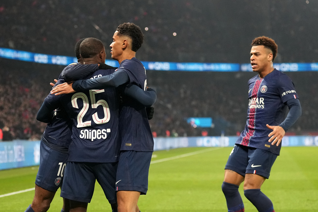 PSG's Ousmane Dembele celebrates with teammates after scoring the opening goal during the French League One soccer match between Paris Saint-Germain and Marseille in Paris, Sunday, Feb. 8, 2026. (AP Photo/Thibault Camus)