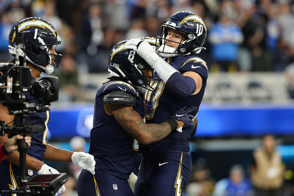 Los Angeles Chargers running back Omarion Hampton (8) celebrates his touchdown with quarterback Justin Herbert (10) during the second half of an NFL football game against the Houston Texans Saturday, Dec. 27, 2025, in Inglewood, Calif. (AP Photo/Kevork Djansezian)