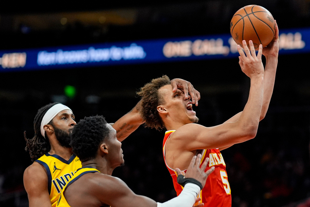 Atlanta Hawks guard Dyson Daniels (5) shoots against Indiana Pacers guard Bennedict Mathurin (00) during the second half of an NBA basketball game, Monday, Jan. 26, 2026, in Atlanta. (AP Photo/Mike Stewart)