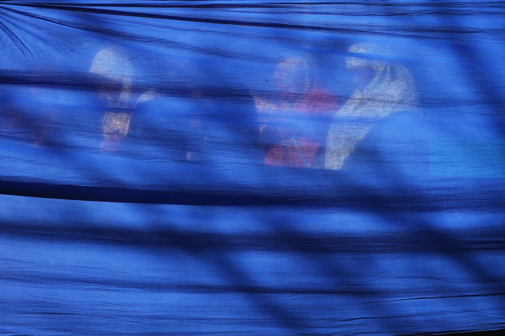 Women pray behind a curtain during Eid al-Fitr, the Muslim holiday marking the end of Ramadan, Islam's holy month of fasting, in Rome's Piazza Vittorio, Friday, March 20, 2026. (AP Photo/Alessandra Tarantino)