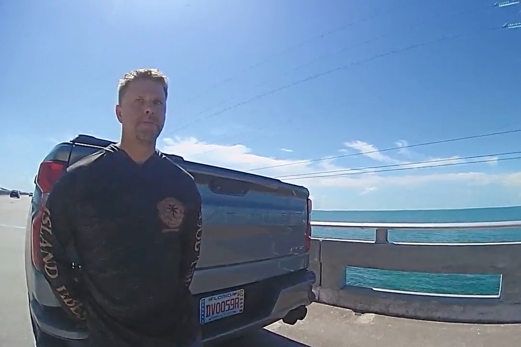In this screengrab made from body camera footage provided by the Monroe County, Fla., Sheriff's Office, off-duty U.S. Immigration and Customs Enforcement agent Scott Deiseroth takes a field sobriety test after he was pulled over for drunk driving with his children in the car in August 2025. (Monroe County Sheriff's Office via AP)
