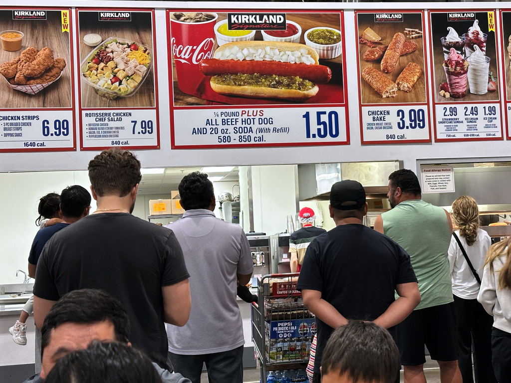 Customers wait their order in a food court at a wholesale store in Mount Prospect, Ill., Monday, June 8, 2026. (AP Photo/Nam Y. Huh)