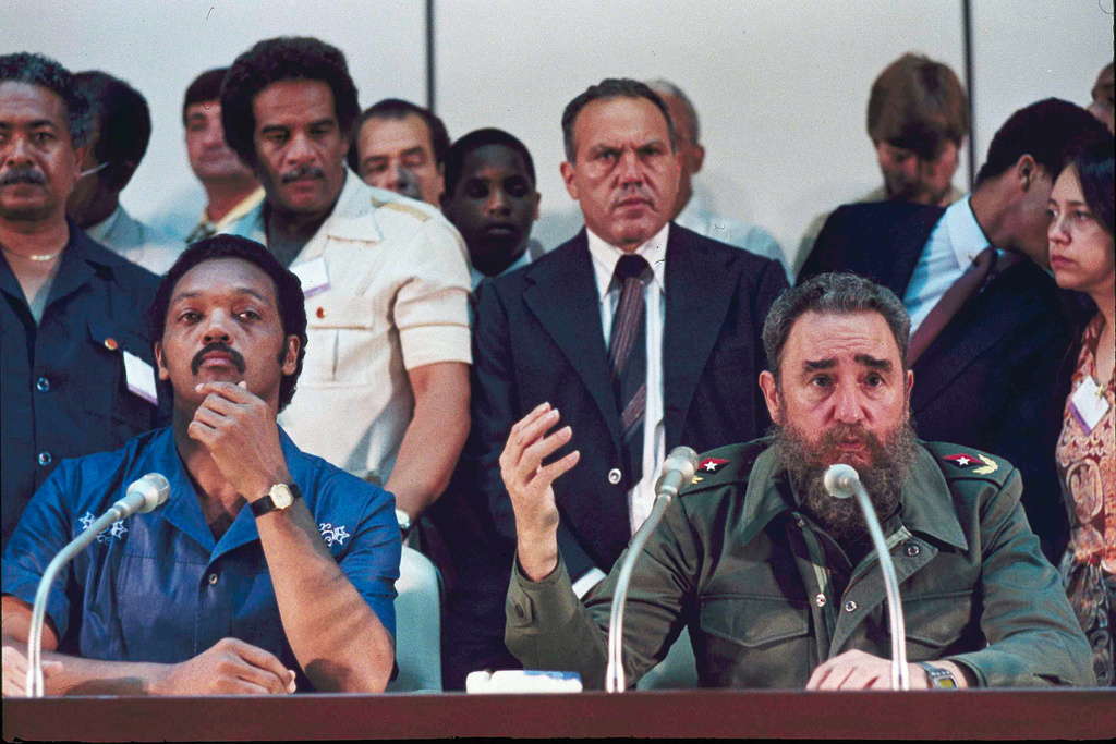 FILE - Cuban Premier Fidel Castro, right, and Rev. Jesse Jackson talk to the international media during a joint news conference, following the end of their marathon meeting at Havana's National Palace, June 27, 1984, when it was announced that 22 Americans would be freed from Cuban jails. Others are unidentified. (AP Photo/Charles Tasnadi, File)