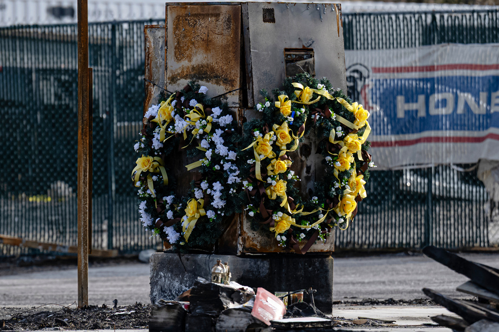 Wreaths displayed to honor those lost during the incident are seen during a tour of the UPS plane crash site, Tuesday, Jan. 13, 2026, in Louisville, Ky. (AP Photo/Jon Cherry)