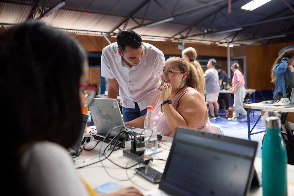 Jorge Reyes and Andrea Saavedra work through prompts together at the Quili.AI headquarters Jan. 31, 2026, in Quilicura, Chile. (Jota Velasquez/Tombras via AP)