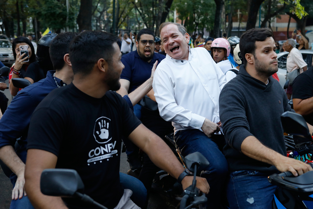 Opposition leader Juan Pablo Guanipa rides on the back of a motorcycle after his release from prison in Caracas, Venezuela, Sunday, Feb. 8, 2026.(AP Photo/Cristian Hernandez)