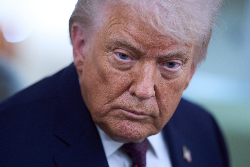 President Donald Trump speaks with reporters aboard Air Force One after leaving the World Economic Forum in Davos for Washington, Thursday, Jan. 22, 2026. (AP Photo/Evan Vucci)