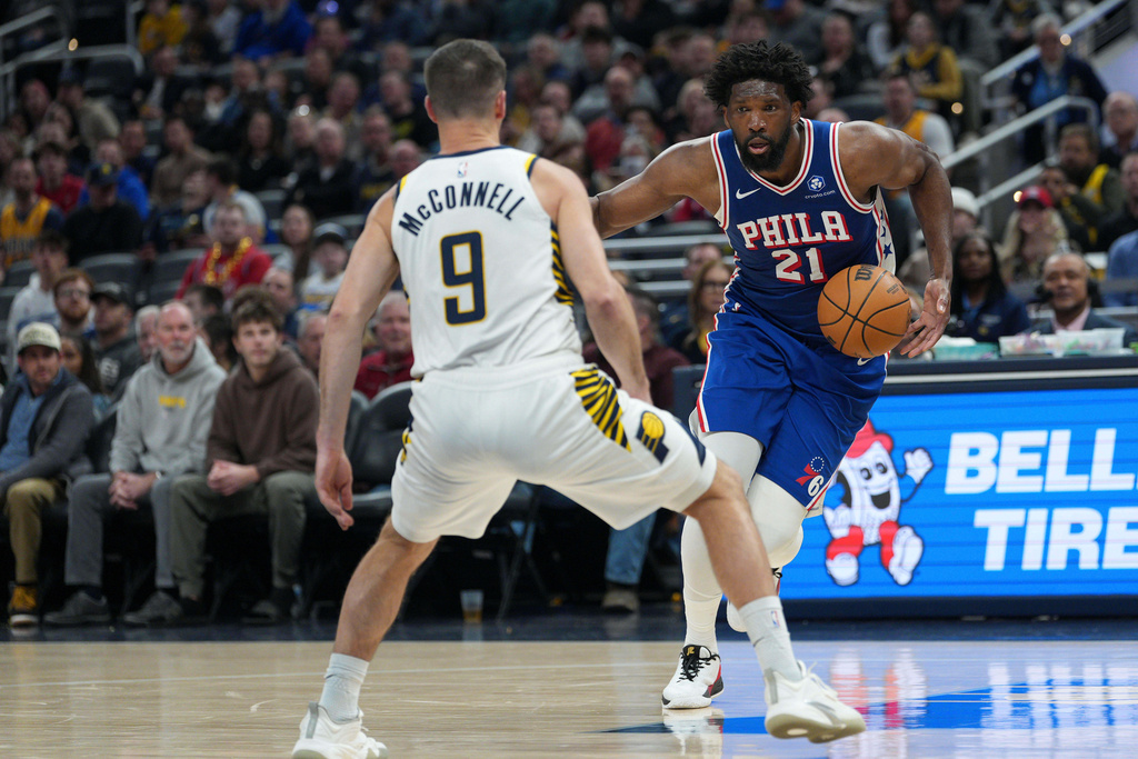 Philadelphia center Joel Embiid (21) looks to move around Indiana guard T.J. McConnell (9) during the first half of an NBA basketball game in Indianapolis, Tuesday, Feb. 24, 2026. (AP Photo/AJ Mast)