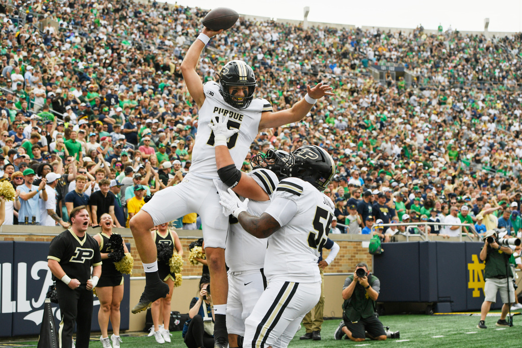 Purdue quarterback Ryan Browne (15) celebrates with teammates in the end zone after catching a 14 yard touchdown pass from running back Devin Mockobee during the first quarter of an NCAA football game against Notre Dame, Saturday, Sept. 20, 2025, in South Bend, Ind. (AP Photo/Paul Beaty)