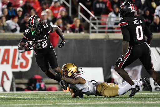 Boston College defensive back Omar Thornton, center, grabs the legs of Louisville running back Keyjuan Brown (22) during the second half of an NCAA college football game in Louisville, Ky., Saturday, Oct. 25, 2025. (AP Photo/Timothy D. Easley) Boston College defensive back Omar Thornton, center, grabs the legs of Louisville running back Keyjuan Brown (22) during the second half of an NCAA college football game in Louisville, Ky., Saturday, Oct. 25, 2025. (AP Photo/Timothy D. Easley)