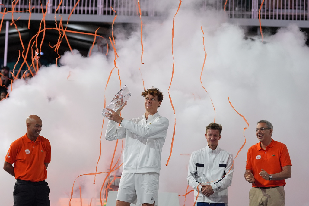 Jannik Sinner of Italy, center, hosts the Butch Buchholz trophy after defeating Jiri Lehecka of the Czech Republic, second right, in the men's singles final at the Miami Open tennis tournament, Sunday, March 29, 2026, in Miami Gardens, Fla. (AP Photo/Rebecca Blackwell)