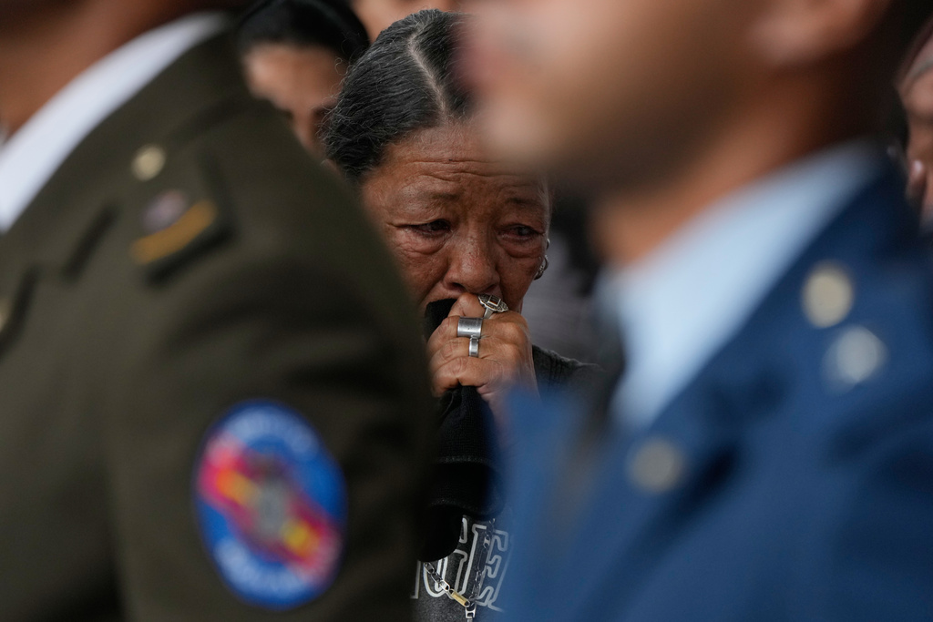 Relatives of soldiers killed in the U.S. raid to capture Venezuelan President Nicolas Maduro and his wife mourn during the soldiers' funeral in Caracas, Venezuela, Wednesday, Jan. 7, 2026. (AP Photo/Ariana Cubillos)