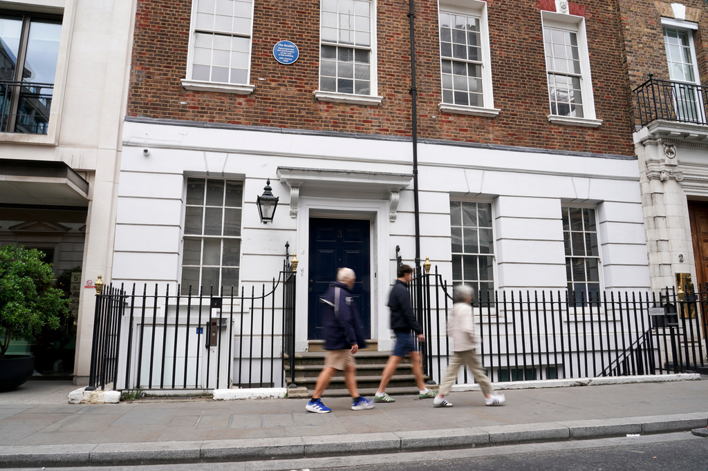 People walk past the building in Savile Row where The Beatles held their last ever concert as a band, which is due to be turned into a fan museum in 2027, in London, Sunday, May 10, 2026. (AP Photo/Alberto Pezzali)