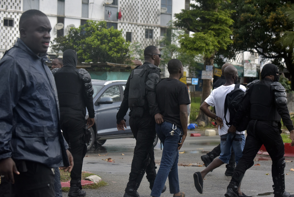 Police arrest a protester during clashes with opposition supporters in Abidjan, Ivory Coast, Saturday, Oct. 11, 2025 (AP Photo/Diomande Ble Blonde)