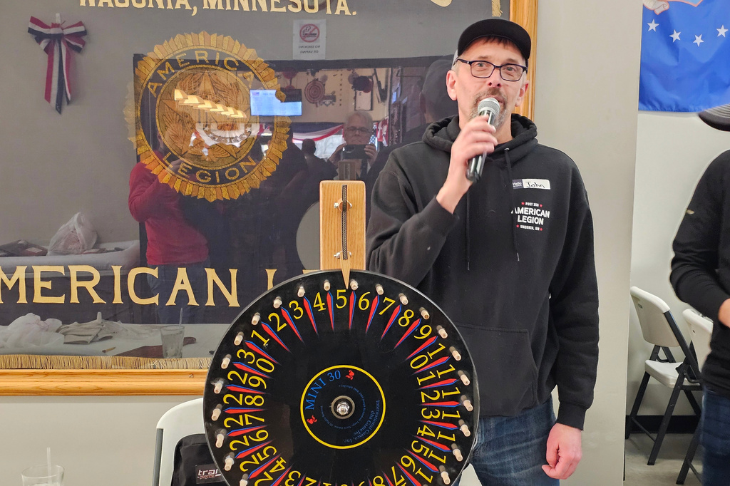 Volunteer John Sartwell announces the winning numbers during a meat raffle April 10, 2026, at American Legion Post 150 in Waconia, Minn. (AP Photo/Steve Karnowski)