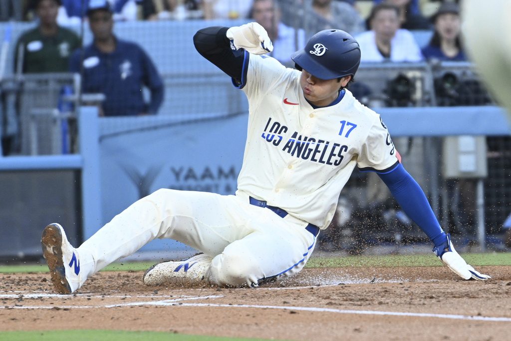 Los Angeles Dodgers two-way player Shohei Ohtani scores against the San Diego Padres during the second inning of a baseball game Saturday, Aug. 16, 2025, in Los Angeles. (AP Photo/Wally Skalij)