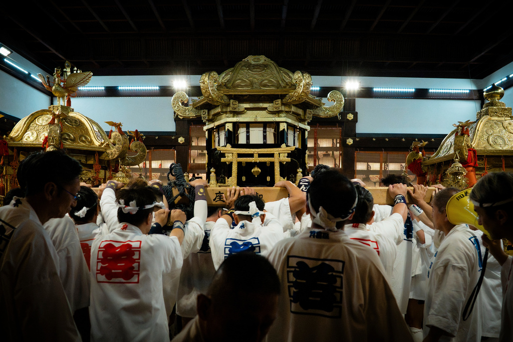 Festival participants carry Yasaka Shrine's Eastern Mikoshi back into the shrine's main hall following the "Mikoshi Arai" purification ritual ahead of the Gion Matsuri festival in Kyoto, western Japan, Friday, July 10, 2026. (AP Photo/Fred Mery)